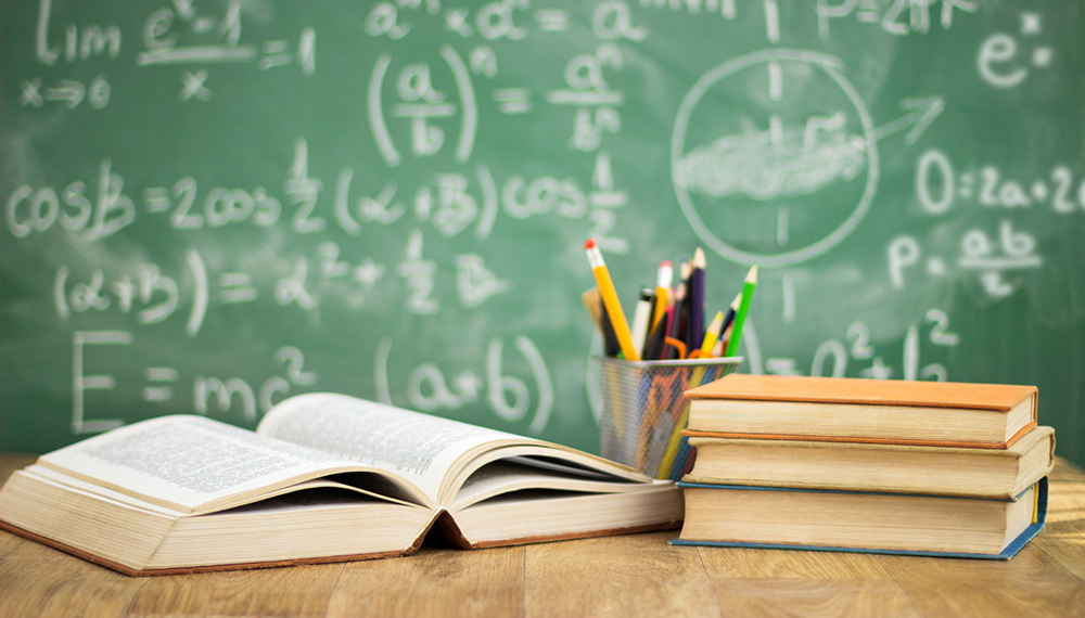 School books on desk, education concept